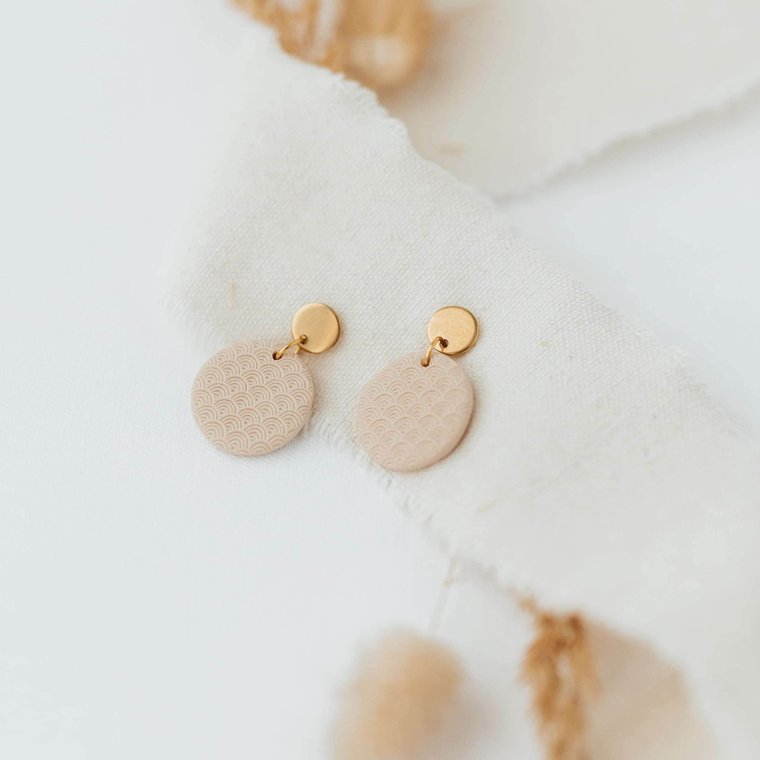 Moderne christliche Ohrschmuck mit goldenen Kreisen und pastellfarbenen Anhängern.