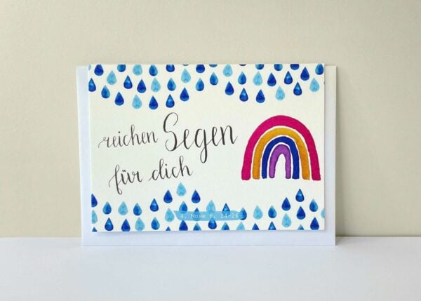 Segenskarte mit Regenbogen und blauen Regentropfen, christliche Geschenkidee.