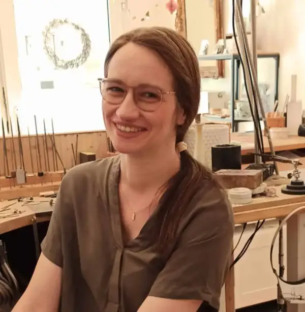 Haarige Frau im Werkraum, Kunsthandwerk und Schmuckherstellung, handgefertigte Schmuckstücke.