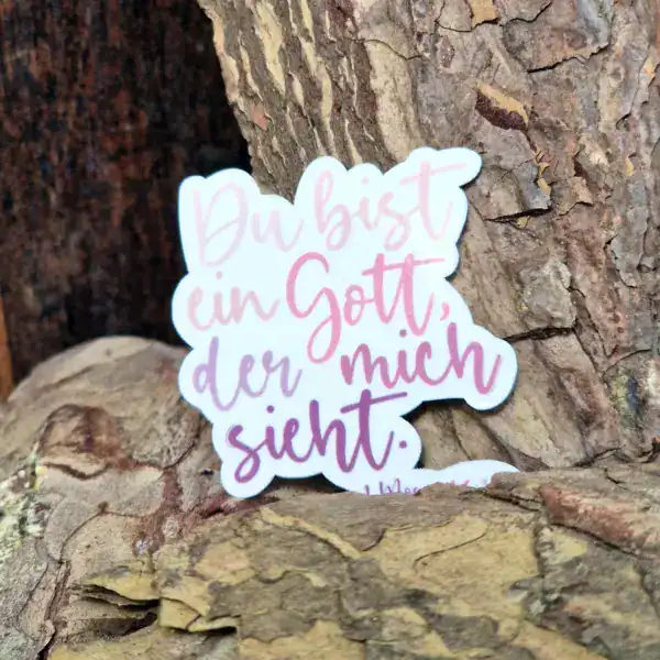 Gottes-Sprüchesticker auf Baumstamm, christliche Botschaft, religiöse Dekoration.